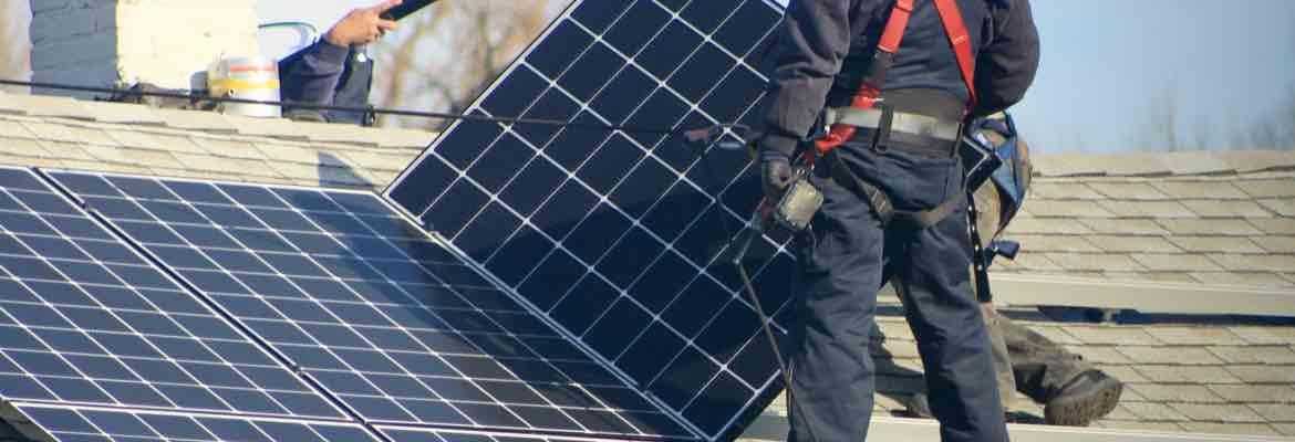 Solar Installers On A Roof